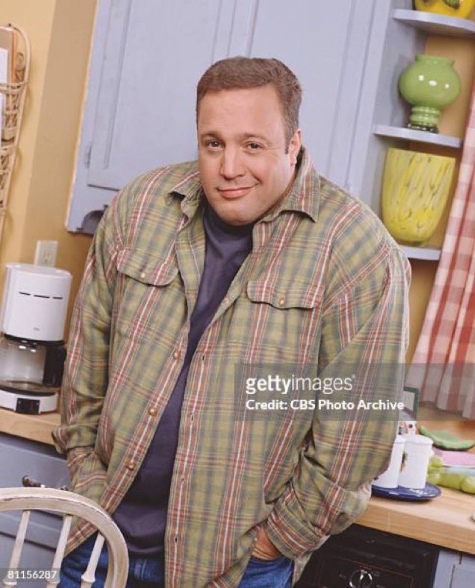Kevin James wearing a flannel shirt and a sheepish smirk